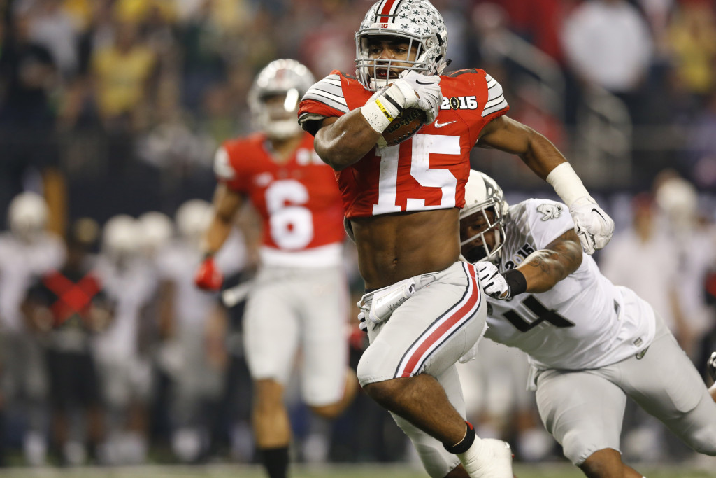 Jan 12, 2015; Arlington, TX, USA; Ohio State Buckeyes running back Ezekiel Elliott (15) runs with the ball against Oregon Ducks defensive back Erick Dargan (4) during the first quarter in the 2015 CFP National Championship Game against the Oregon Ducks at AT&T Stadium. Mandatory Credit: Matthew Emmons-USA TODAY Sports